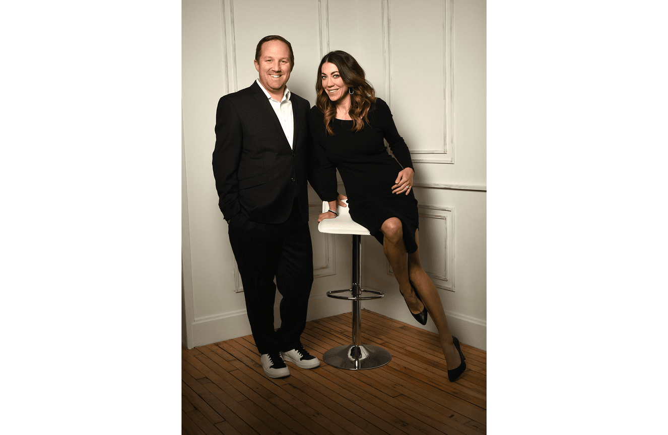 This dynamic duo in a black sports suit and cocktail dress pose at Kliks.