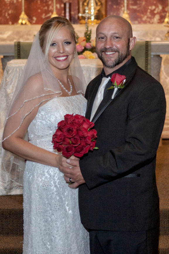 From Kristin & Rocky's wedding, she is holding a bouquet of red roses in the church, with Paul ofr PBM Photography. I've had the ultimate and distinct pleasure actually photographing her 1st & 2nd wedding.