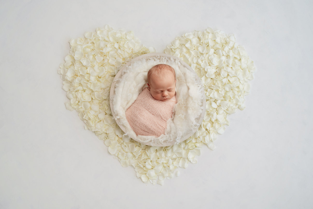 newborn girl posed in a heart bowl raleigh NC newborn photography