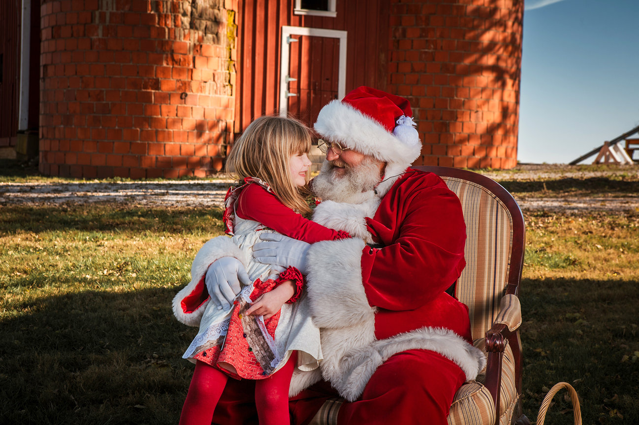 Santa embraces a child during a previous Kay Web Photography Christmas experience
