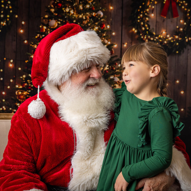 Santa and a child share a conversation during a past session