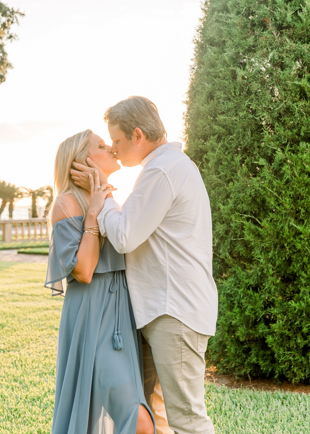 couple kissing in a manicured garden in Jacksonville, Florida, pregnant woman kissing her husband